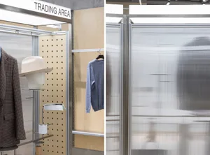 A trading area display featuring metal shelving and clothing racks.