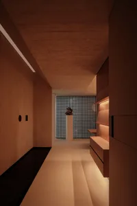 A minimalist interior with light wood panels and concrete elements.