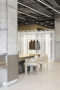 A modern retail storefront with concrete walls and a minimalist design.