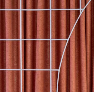 A close-up of orange curtains with a white grid pattern