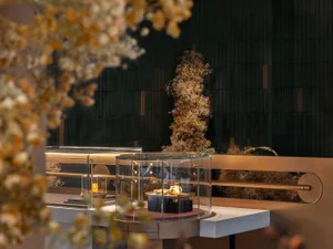 An industrial-style retail showcase featuring glass, metal, and concrete elements.