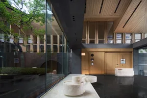 Modern building interior featuring marble, wood, and concrete materials.