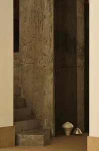 Concrete staircase and column in an interior space.