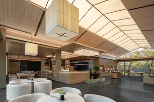Modern coworking space featuring marble, wood, and glass materials and minimalist design