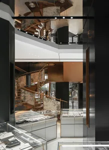A modern jewelry shop featuring metallic and glass decor, with a focus on the elegant display cases and the stylish interior 