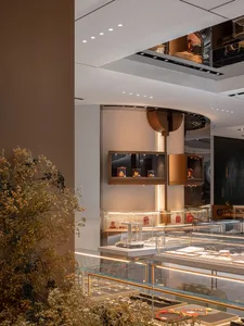 Interior view of a contemporary jewelry store with glass display cases showcasing jewelry.