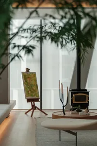 A modern living room with a mix of materials including wood, glass, and metal.