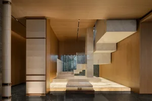 Modern lounge area with marble floor and walls, showcasing contemporary design elements.