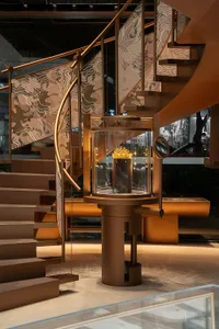 Modern retail shop featuring metal railings and a glass display case.