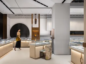 A modern retail store featuring glass showcases, metal accents, and wooden furniture.