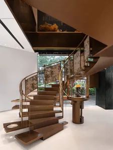 Modern staircase with metal railings and steps, featuring a contemporary design.