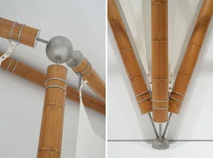 Close-up of industrial interior design with bamboo tubes, metallic fittings, and textile elements.