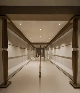 A minimalist fashion showroom with metal and glass elements.