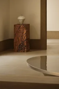 Minimalist interior design featuring a marble cylinder with a round base.