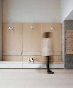 A minimalist living space featuring wooden, concrete, and metallic surfaces.