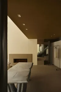 Modern minimalist residential interior with textured cast concrete walls and floors