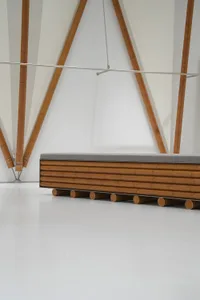 Modern interior design featuring bamboo seating on a white floor.