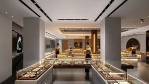 Modern jewelry shop with illuminated glass display cases showcasing various jewelry items.