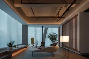 Modern living room featuring natural light, wooden elements, and minimalist furniture