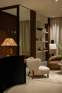 Modern lounge area featuring a mix of materials including wood, fabric, and porcelain.