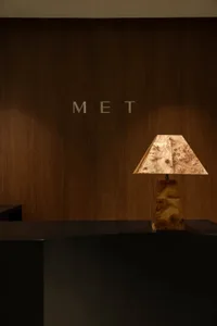 Modern design of a reception desk featuring a wooden lamp base