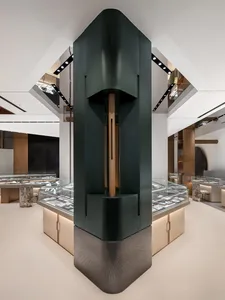A modern retail jewelry shop featuring a prominent black cylindrical column.