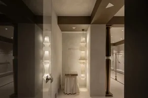 A minimalist modern retail storefront with glass walls and a white interior.