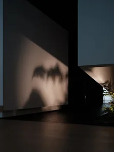 Concrete floor and wall with light fixture reflection