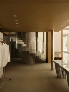 A modern residential interior featuring concrete and glass materials.