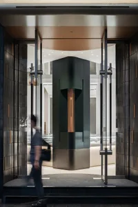 A modern retail storefront featuring glass, concrete, and metal materials.