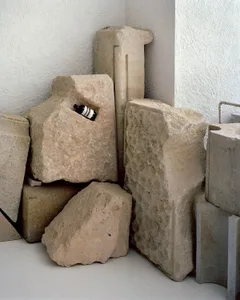 Stone blocks and shapes arranged in minimalist layout.