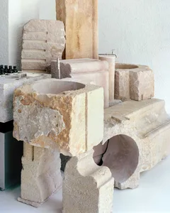 Modern bathroom featuring raw stone sinks and fixtures