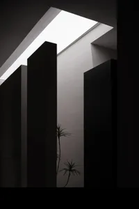 A minimalist interior design featuring modern concrete and glass materials.