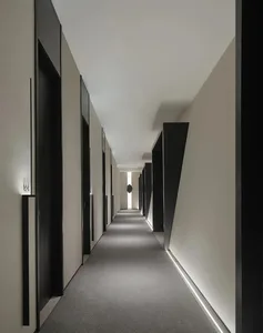 Modern, minimalist corridor with linear lighting and geometric features.
