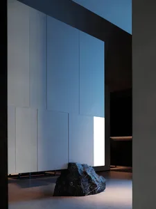 A modern interior space featuring concrete walls and lighting fixtures.