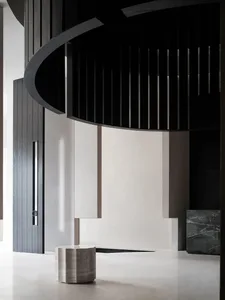 A modern lobby with a concrete floor and black and white color scheme.