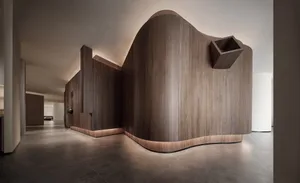 A modern lobby with wood walls and lighting.