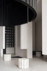 A modern lobby with marble furnishings and curved architectural elements.