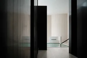 Modern minimalist swimming pool made of glass, viewed from a low angle.