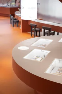 A modern interior design with glass and metal features in a retail store context.