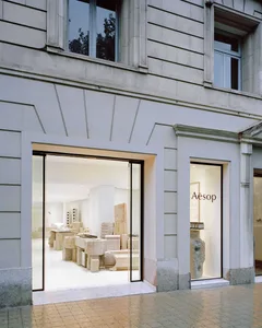 A modern retail storefront with stone elements and a minimalist design.