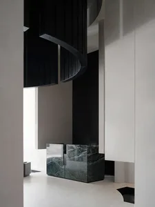 Contemporary entrance hall featuring marble and glass elements