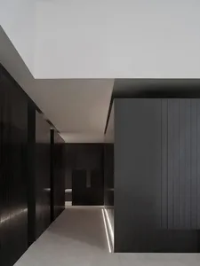 Black and white minimalist office with concrete flooring and walls.