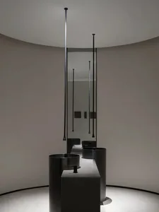 Modern bathroom with sleek black metal sinks and fixtures against a light-colored wall and floor.