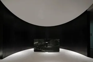A modern lobby featuring dark wood and marble elements.