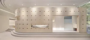 A contemporary retail space featuring concrete walls and glass partitions.