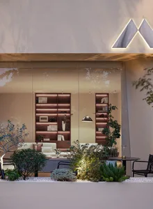 A modern living room with wooden shelves, plants, and comfortable seating.