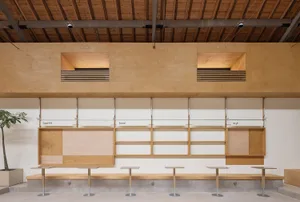 Industrial storefront with wooden shelves and benches.