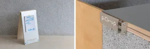 A minimalist pickup counter with a steel surface and metallic brackets attached to a wooden stand.
