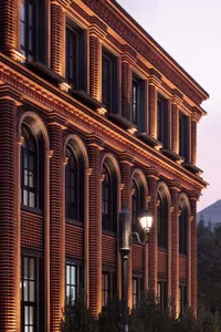 Industrial-style building with brick exterior, large windows, and ornate detailing.